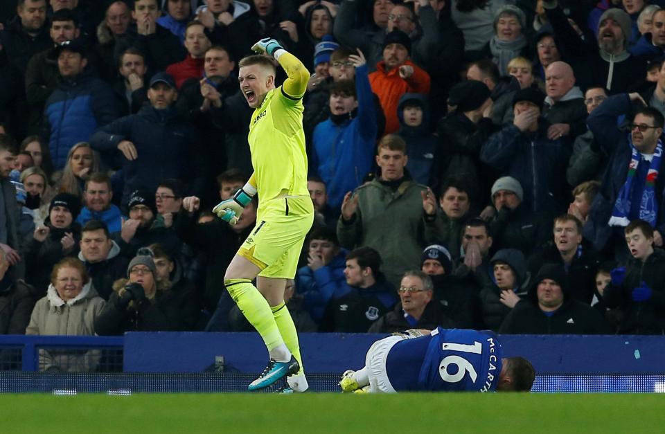  Everton keeper Jordan Pickford frantically waves to call on medical staff for McCarthy