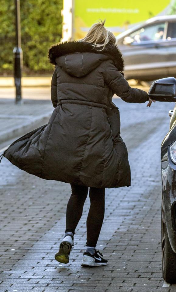  She wrapped up in a large coat and looked like she was well prepped for a workout