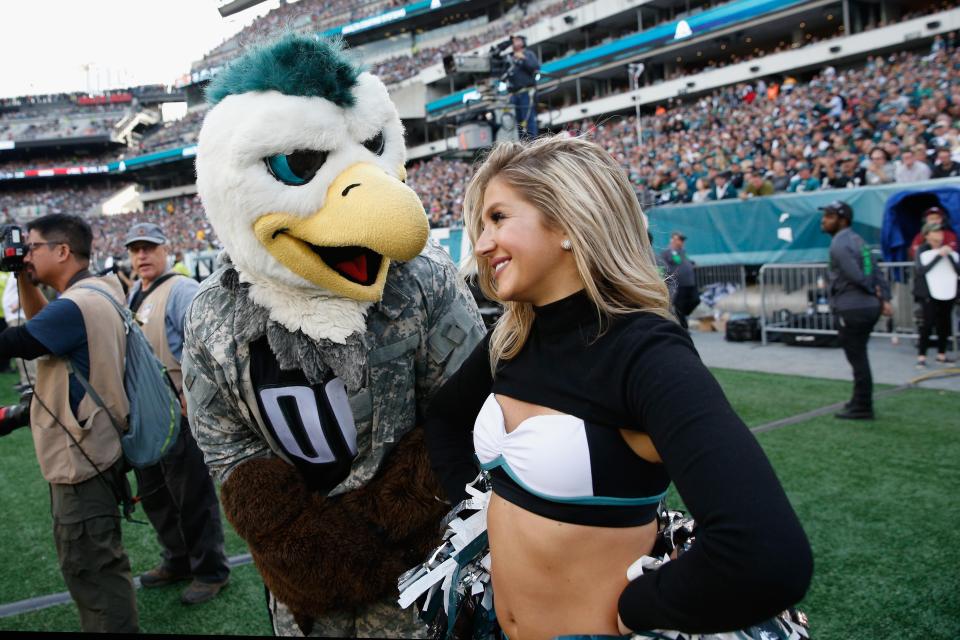  Eagles mascot Swoop talks to a cheerleader at 'The Linc'