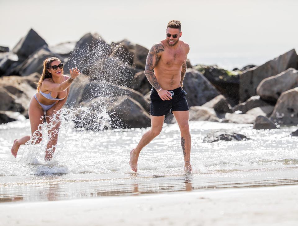  The loved up couple could not keep their hands off each other in the waves