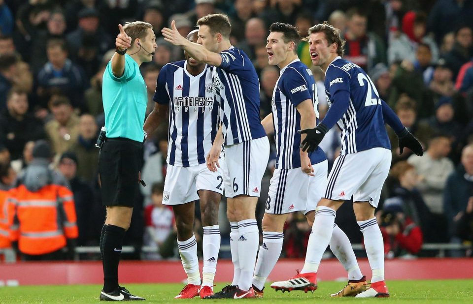  The West Brom players surround Craig Pawson after he awards Liverpool a penalty