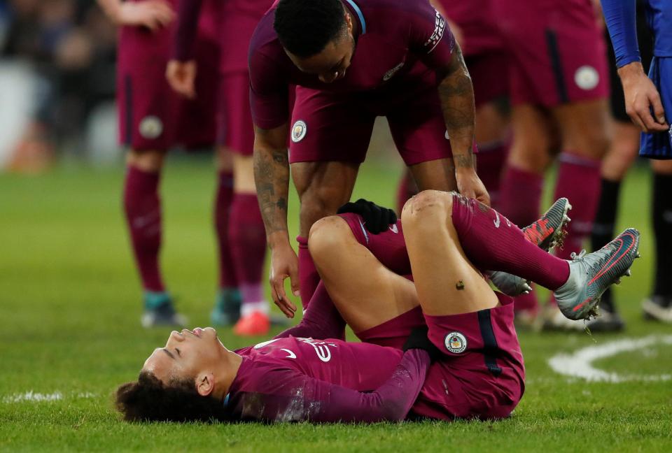  The German international lays on the ground after being brought down by Joe Bennett