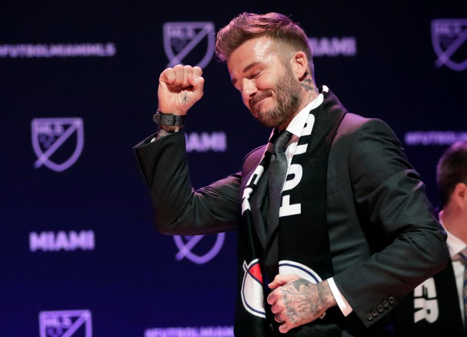  Beckham salutes his fans as they chanted his name during the announcement