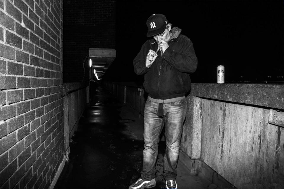  Mark enjoys a hit of crack on a council estate walkway in Harrow Road