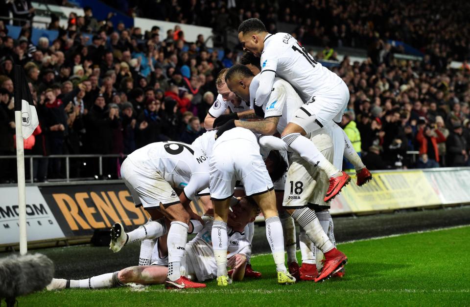  Swansea's players celebrate going two goals ahead through Clucas