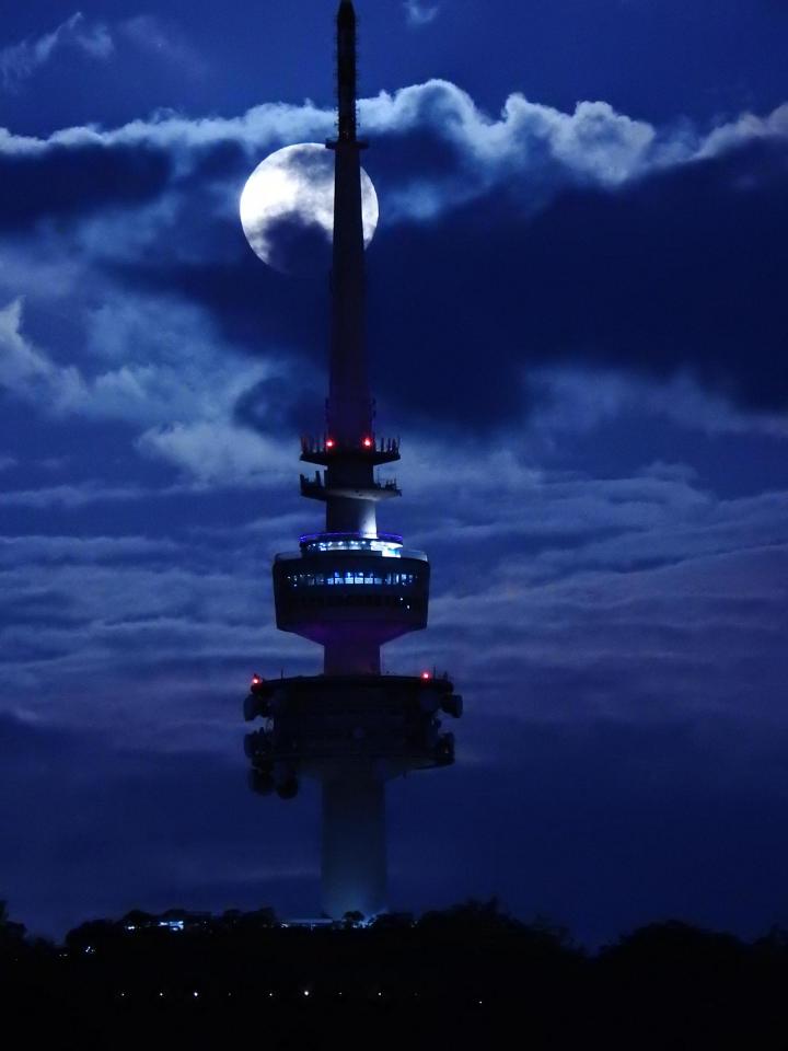  The moon rises behind the Telstra Telecom Tower in Canberra, Australia