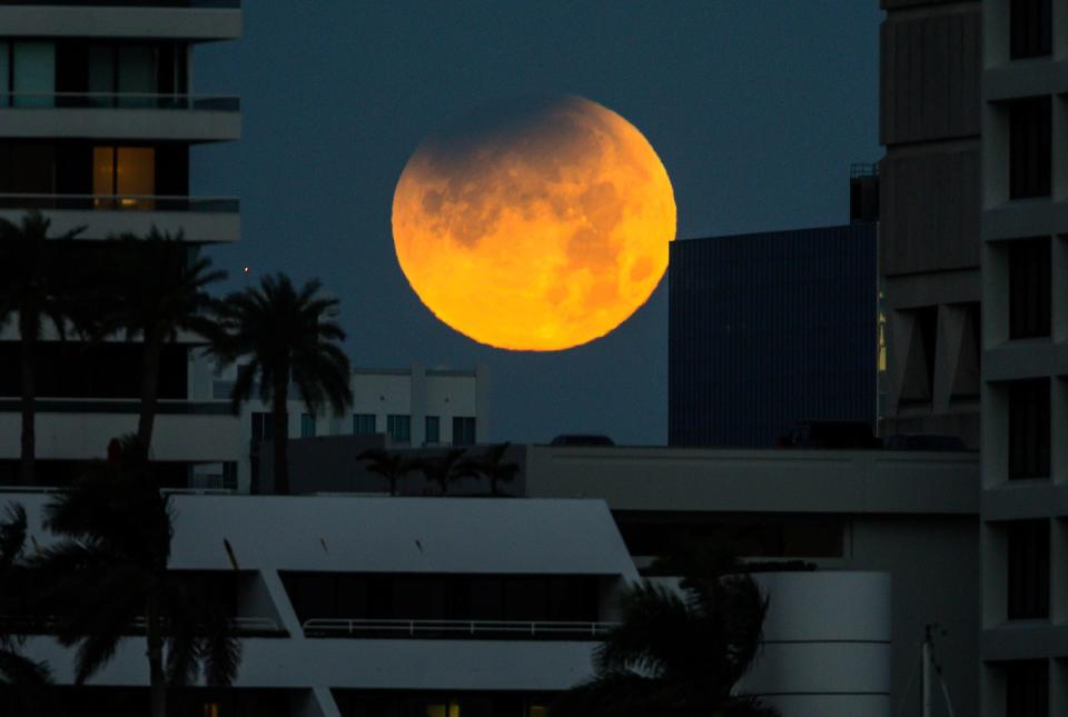  The partially eclipsed moon sets over West Palm Beach in Florida