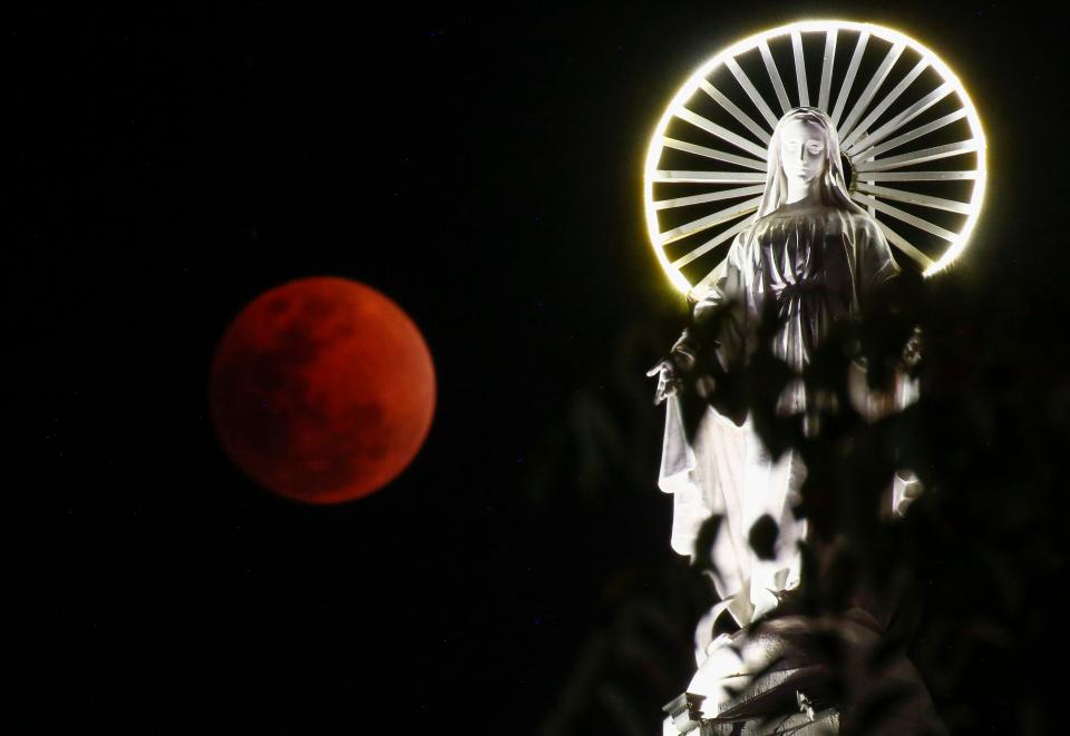  A so-called 'Super Blue Blood Moon' rises over Saint Mary's Cathedral, largest cathedral in Myanmar, in Yangon, Myanma