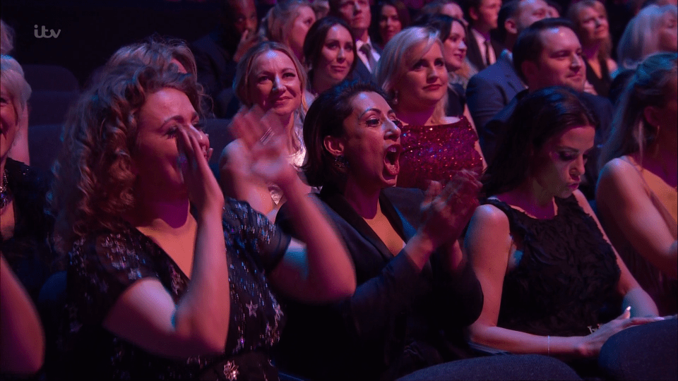  The camera stayed on Katie as she played with her phone, while Nadia and Saira cheered