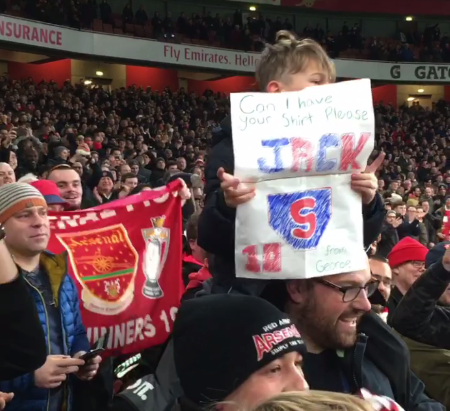  The youngster held up a card asking for Wilshere's shirt