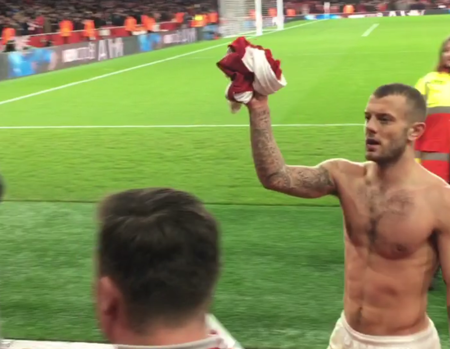  Wilshere walks over a to a section of supporters to hand over his jersey