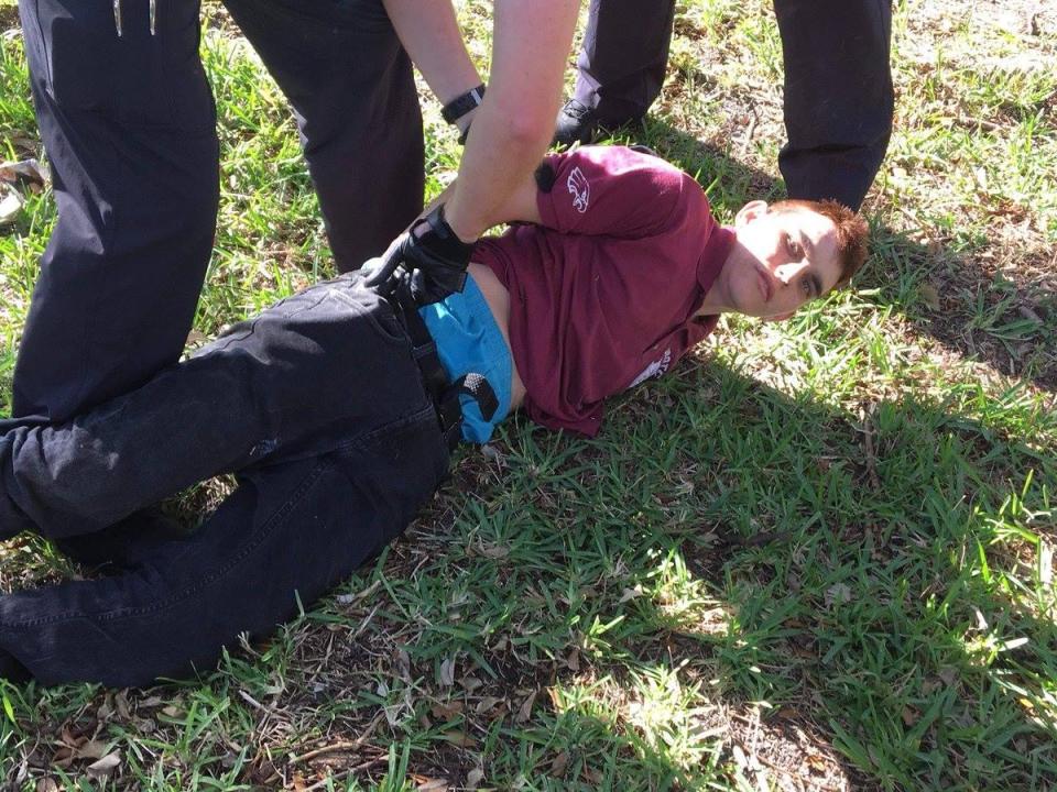  Nikolas Cruz is pinned down on the floor and arrested by cops in the nearby town of Coral Springs around two hours after going on a rampage