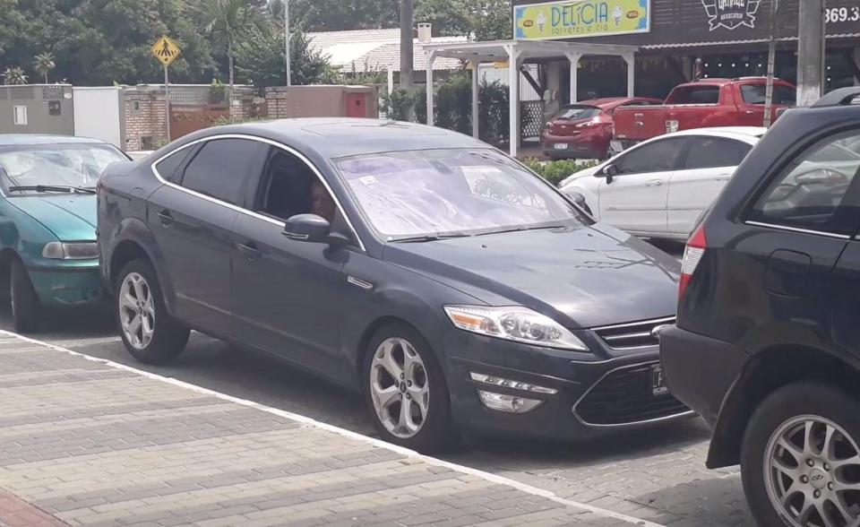  Driver appears to be boxed in by other parked cars