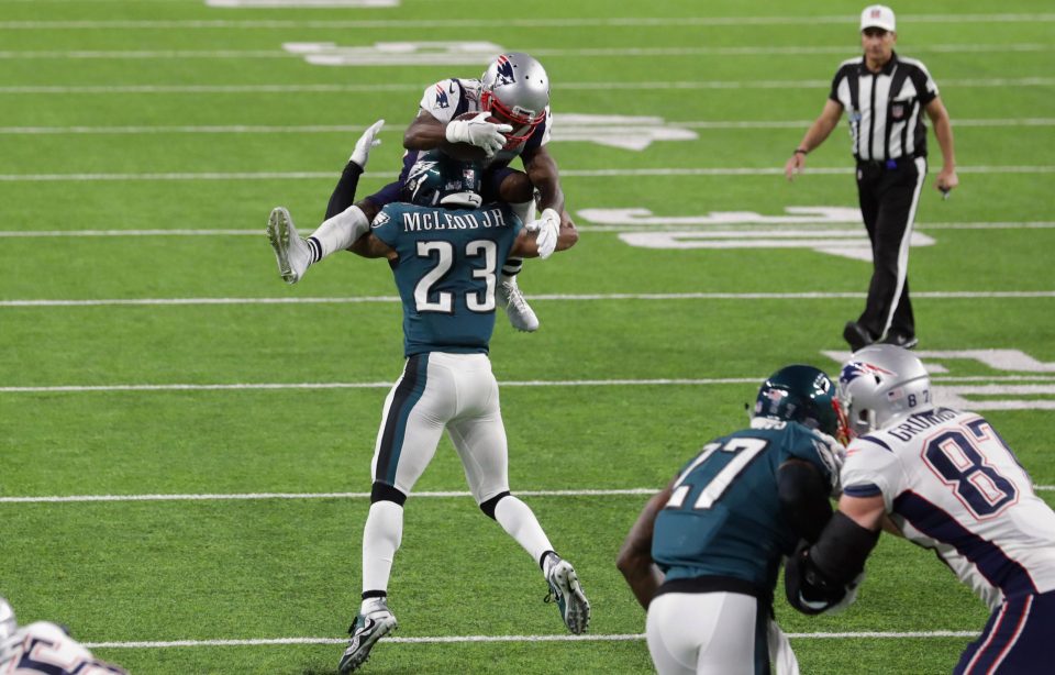  Rodney McLeod tackles an airborne Brandin Cooks