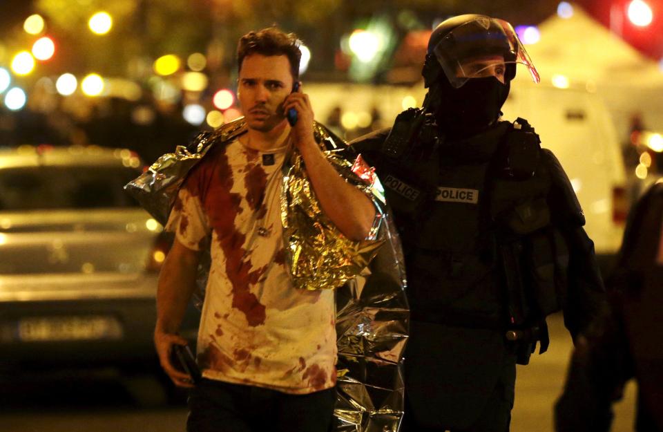 An injured man talks on the phone on the night of the Paris terror attacks