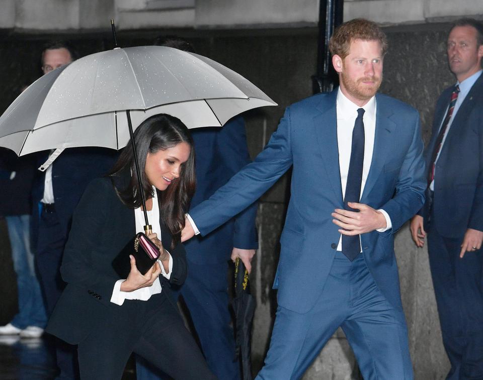  The prince placed a reassuring hand on Meghan's arm as they arrived for their first awards event