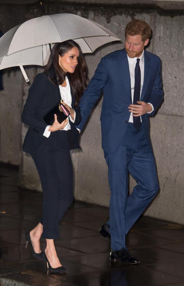  Suits star Meghan Markle wore a smart black suit to the Endeavour Fund awards with husband-to-be Prince Harry