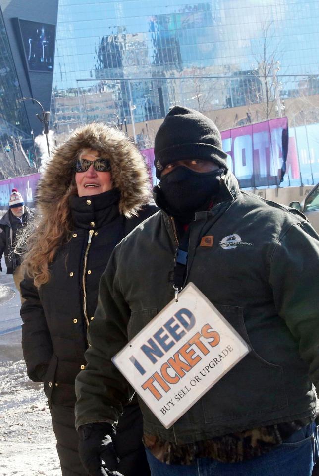  A Gridiron fan wraps up against the cold outside the stadium