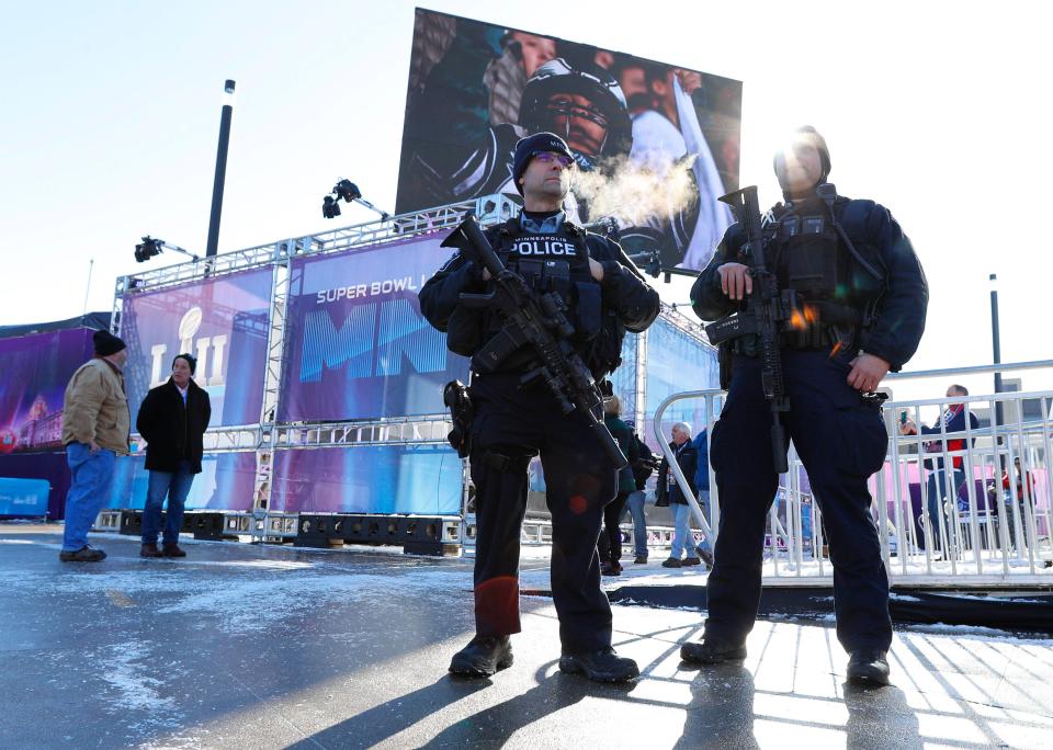  Armed police officers stand at their post in sub-freezing temperatures prior to Super Bowl