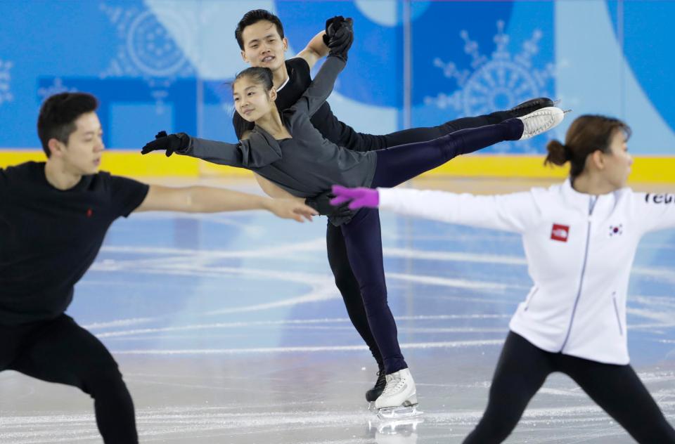  North Korea's Ryom Tae Ok and Kim Ju Sik, centre, practice next to South Korea's Kim Kyueun, front right, and Kam Alex Kang Chan