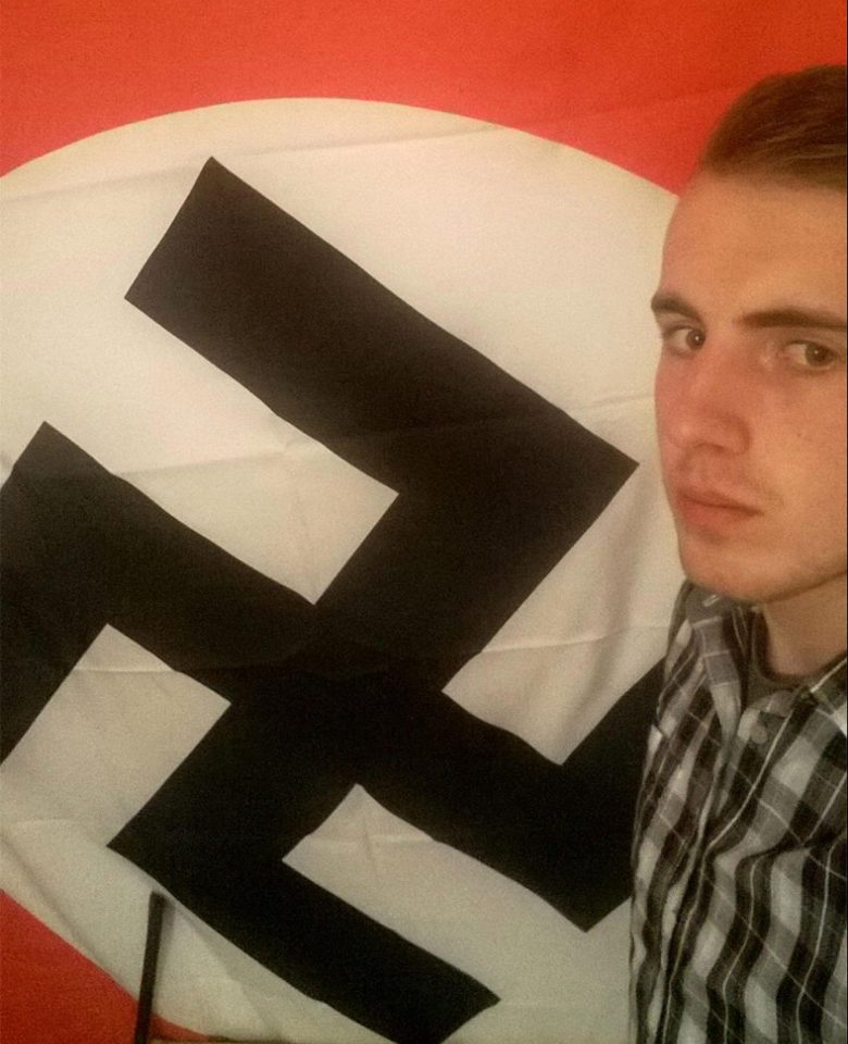  Stables poses in front of a swastika flag in his bedroom in this chilling snap