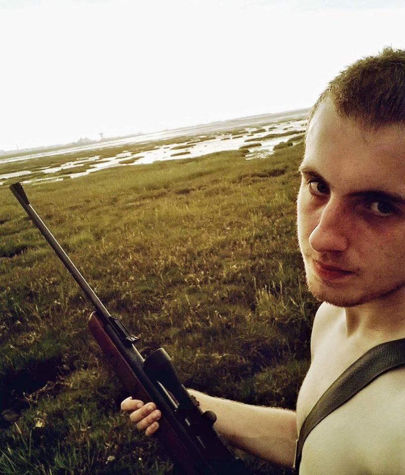  The 20-year-old poses with a rifle in another of the chilling snaps to emerge