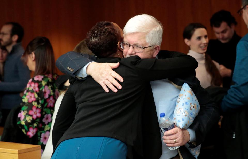 Assistant Attorney General Robyn Liddell hugs the father of former gymnast Ashley Erickson 