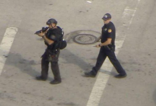  Armed cops are seen in the street amid an ongoing hostage situation