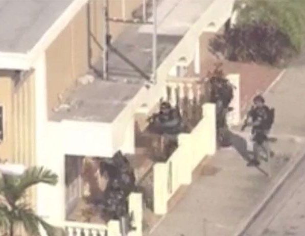  Swat team officers surround the restaurant where the hostages are held