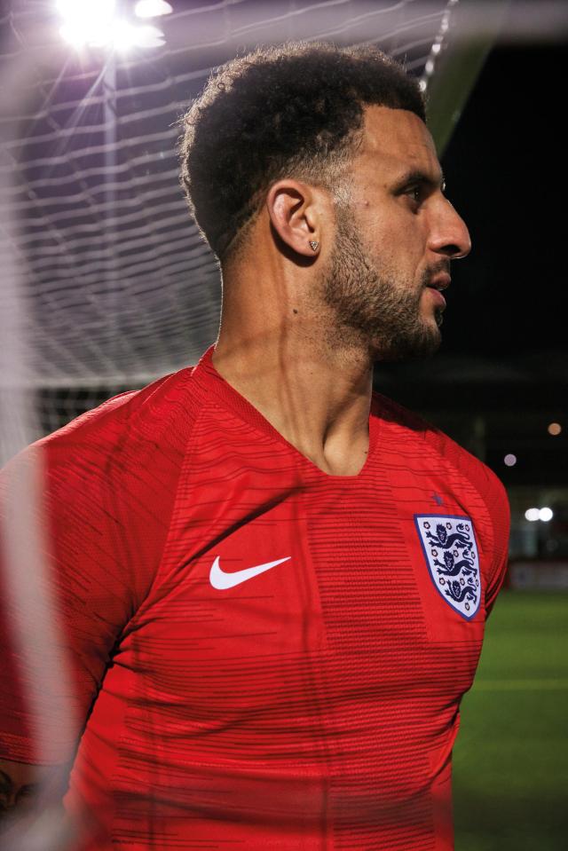  Kyle Walker is shown modelling the new two-tone red away kit