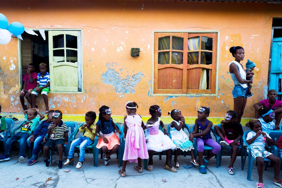 A group of kids celebrate the first birthday of Juan Manuel in the street