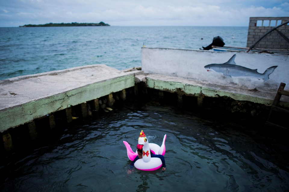 A young child escapes the hustle and bustle of the island for some peace