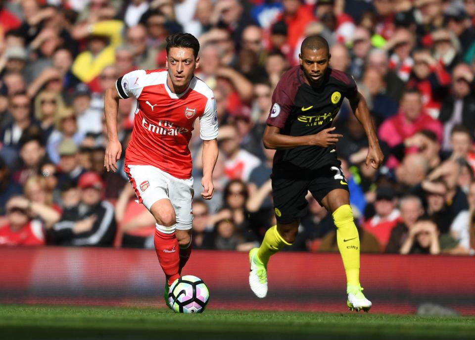  Arsenal ace Mesut Ozil in action against Fernandinho