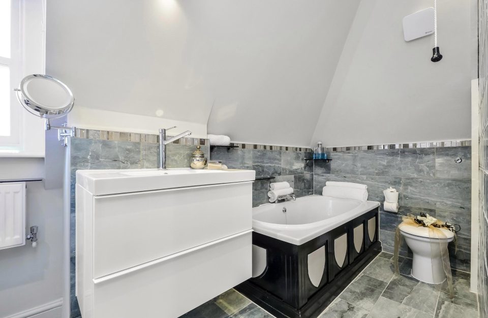  The 1,201 sq ft home also includes a smart bathroom covered in grey tiles