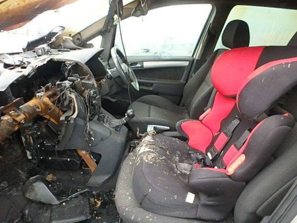 The burned out Vauxhall Zafira with part of its dashboard having been taken out by the manufacturer