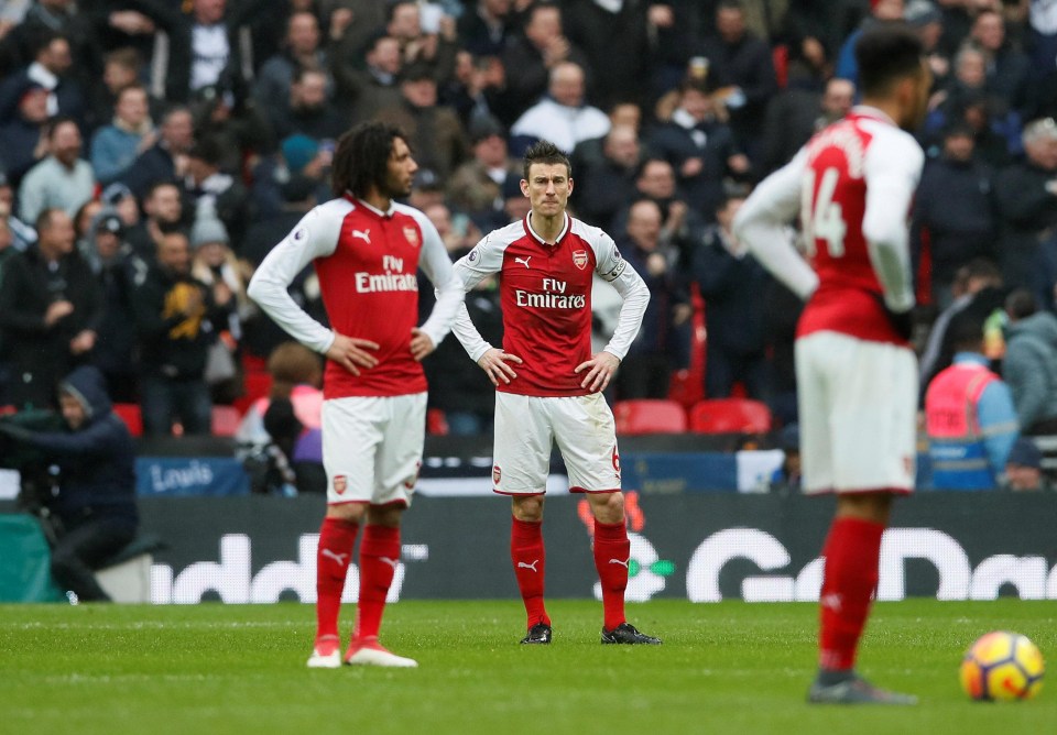 The Arsenal squad look dejected after conceding against the Lilywhites in the North London derby