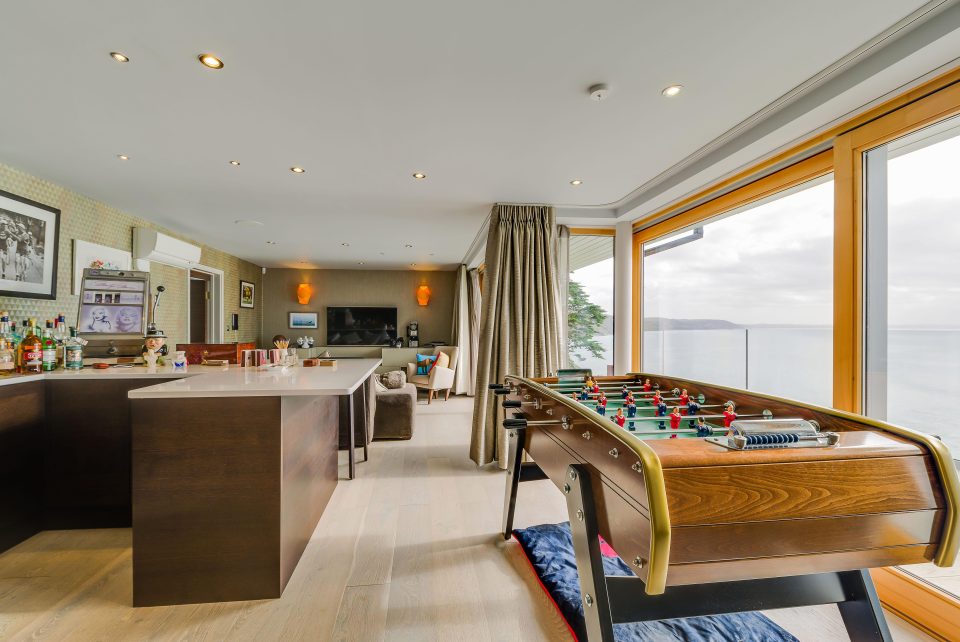  The five bed modern house has an open-plan kitchen/dining room, a library, a games room and bar on the ground floor