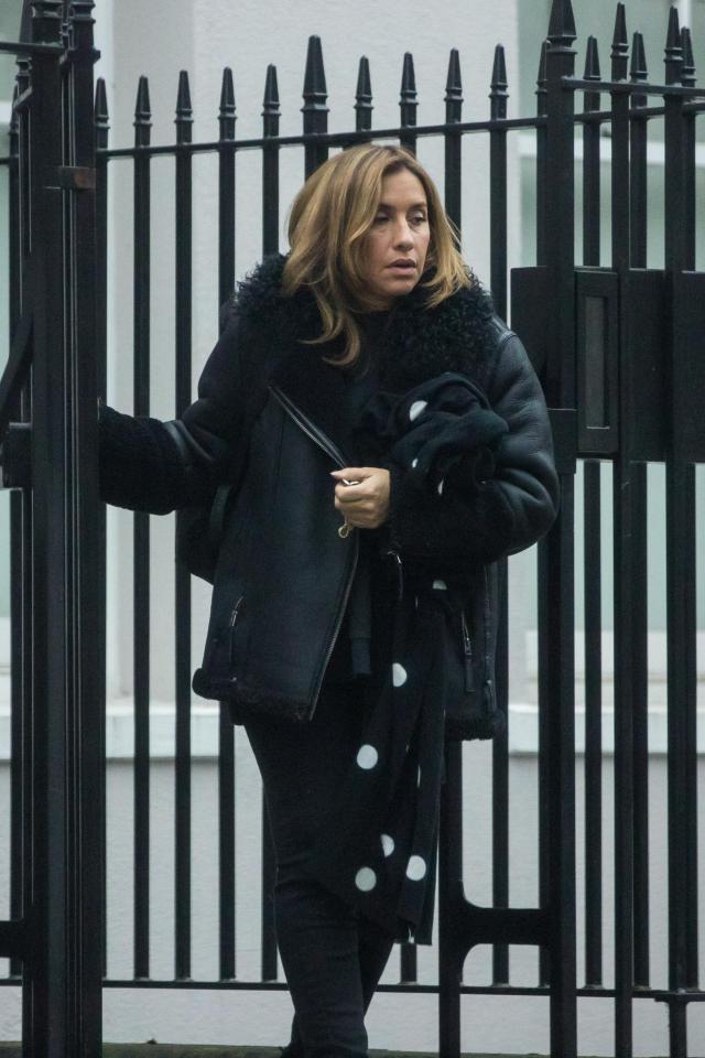  The singer wrapped up all in black and clung to what looked like a polka dot coat she she left