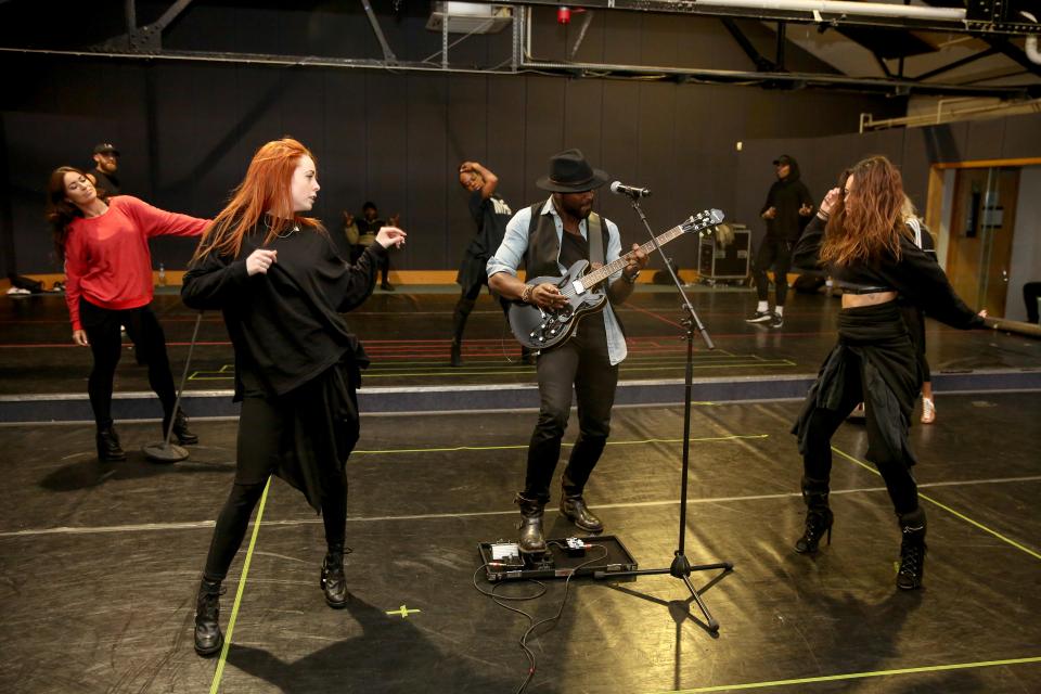  Behind the scenes, Kevin and his dancers warm up