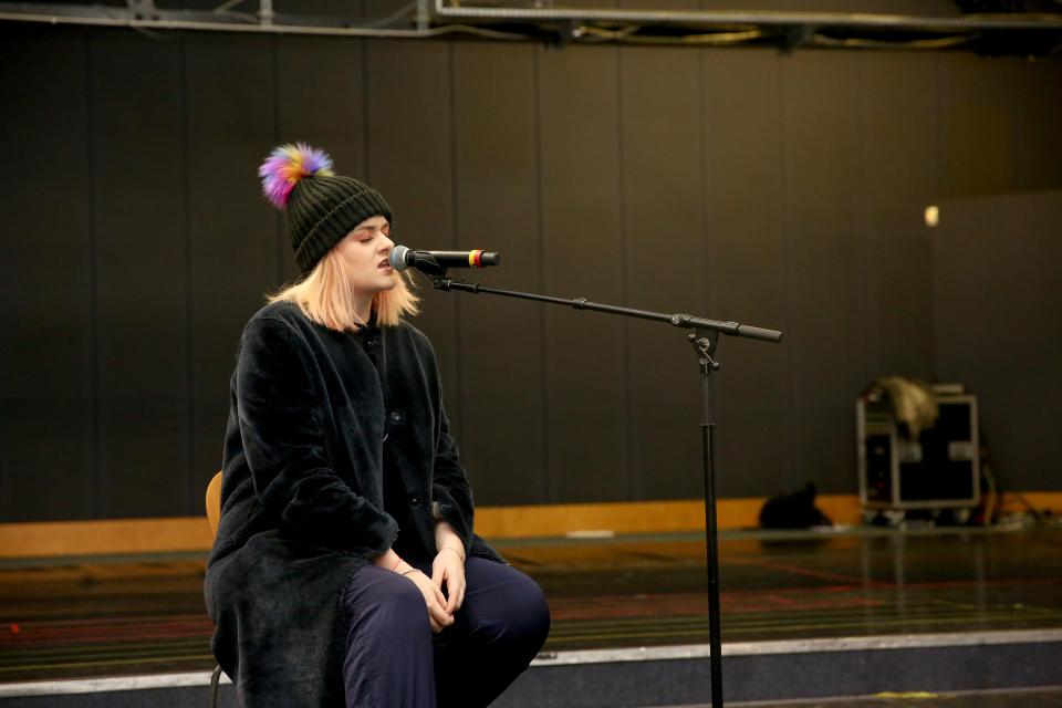  Grace Davies keeps her head cosy at rehearsals as she warms up her vocal chords ahead of the Live Show