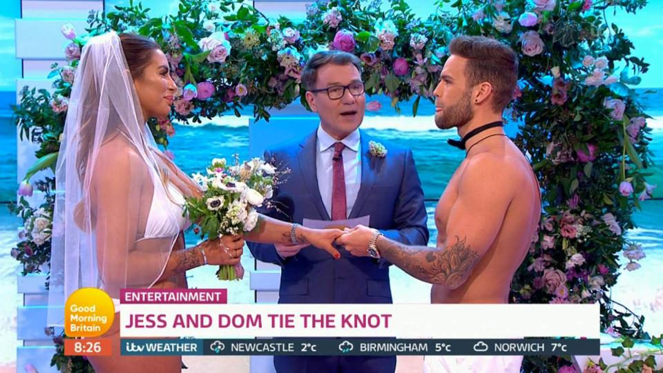  The pair were married by Richard Arnold wearing white swimwear