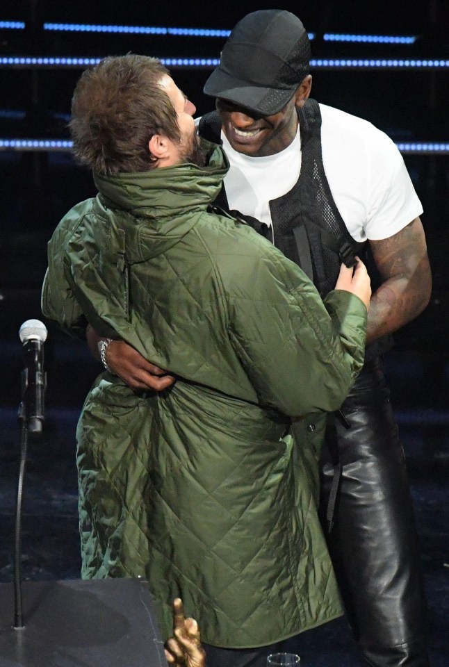 Liam and Skepta in an embrace on stage at the NME Awards show