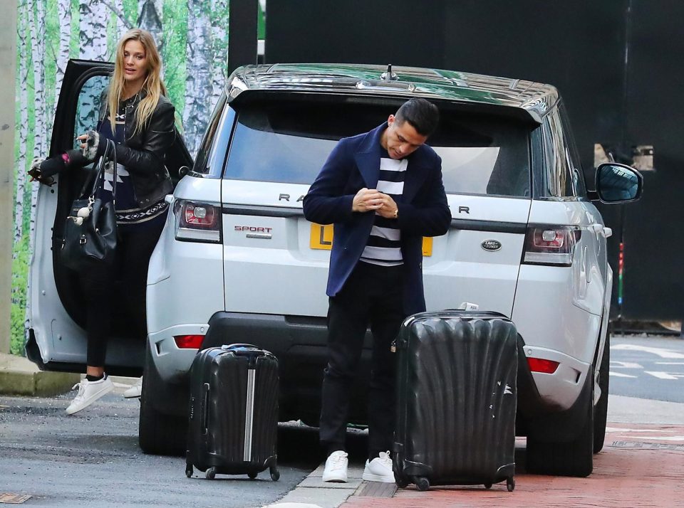  Alexis Sanchez seems to be dressed more smartly than Mayte Rodriguez as he welcomes his girlfriend to the Lowry