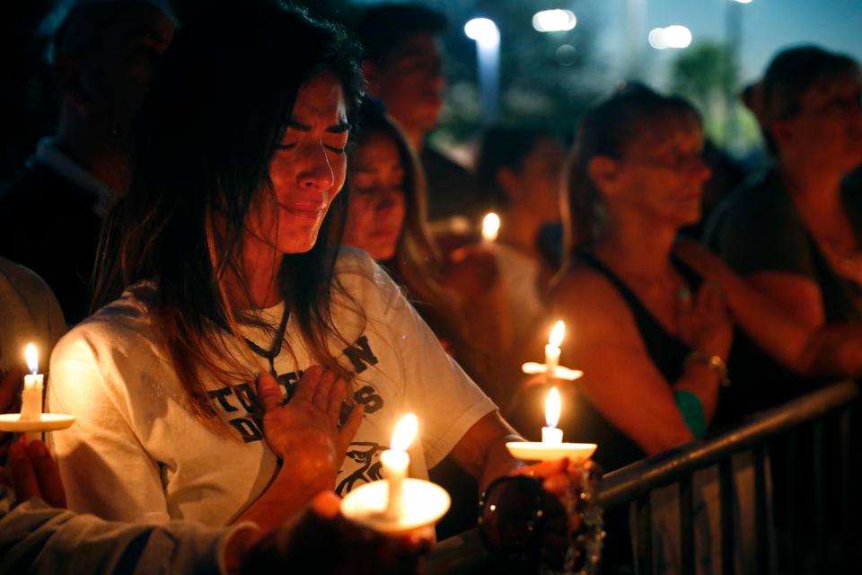  Grieving friends and family members held a moments silence as they remembered those killed