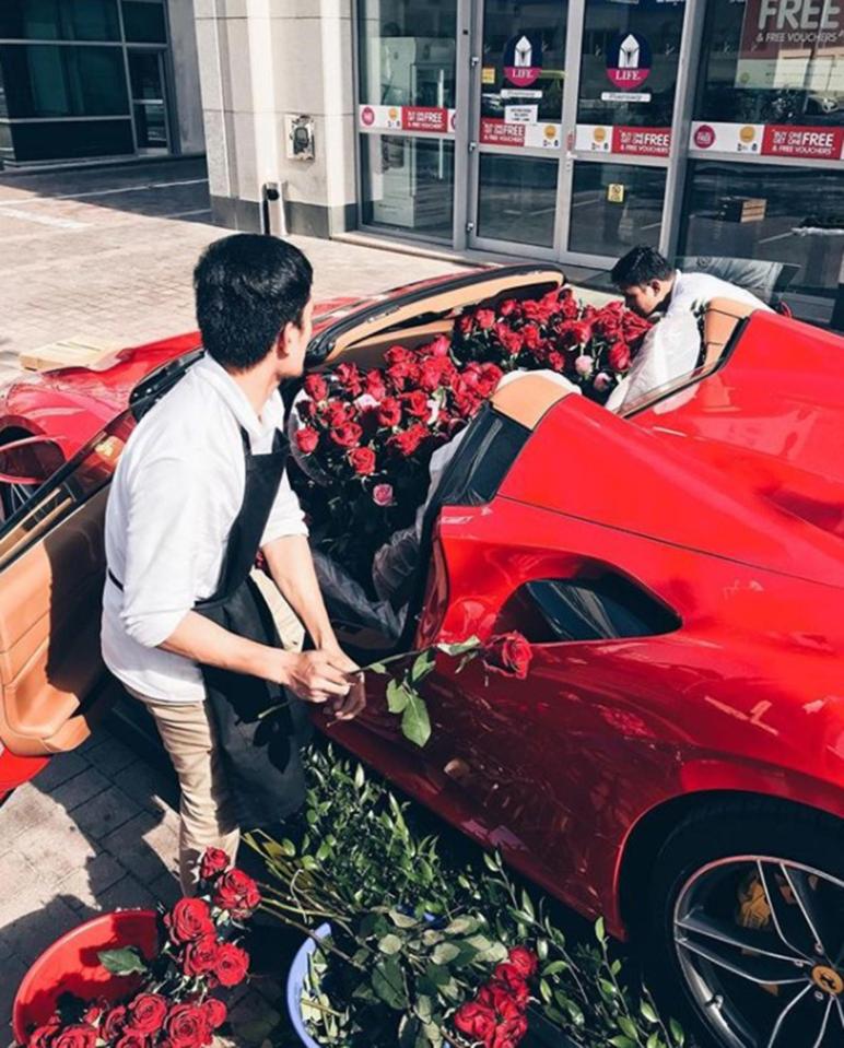  Florists pictured filling the Ferrari with 1,000 red, pink and white roses