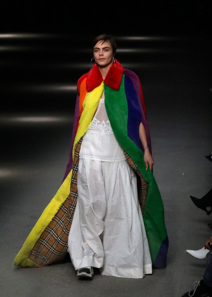 Cara wore a floor-length, rainbow-coloured coat to close Burberry's London Fashion Week show