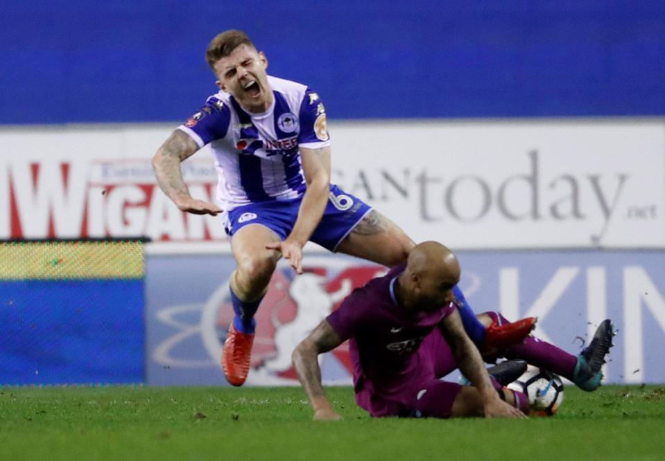  Fabian Delph was shown a straight red for this wild lunge at Wigan's Max Power