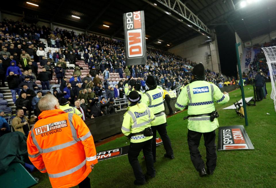  Manchester City fans hurl missiles after their FA Cup defeat to Wigan