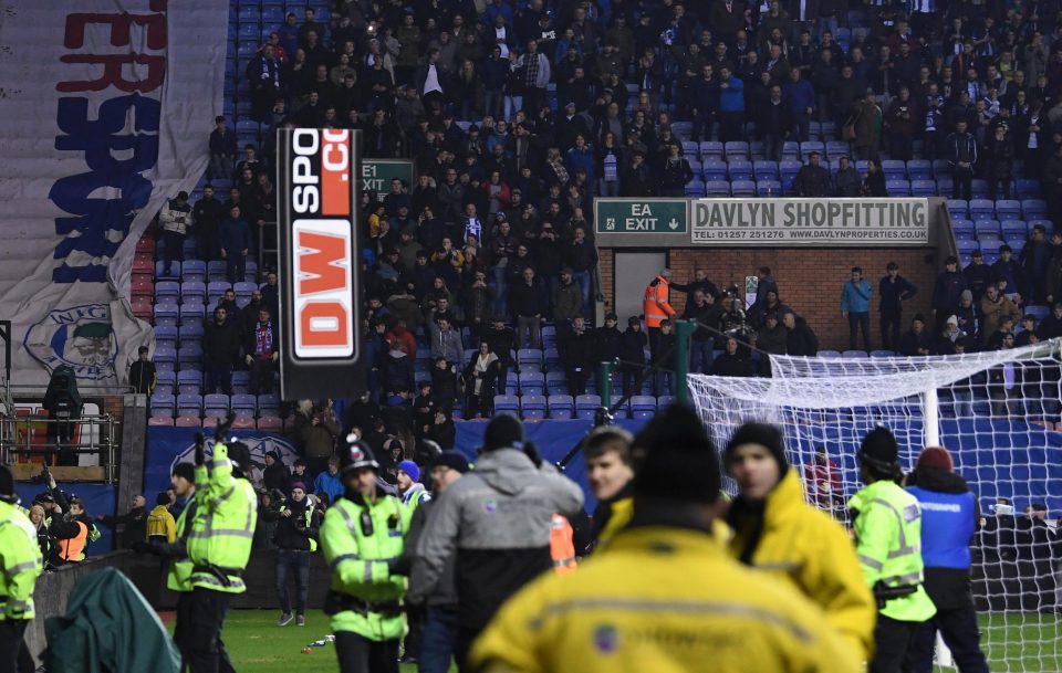  One of the advertising boards flies through the air towards police