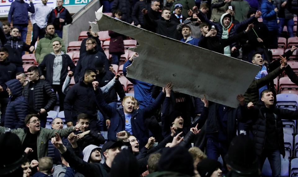  Fans in the away end grabbed advertising boards before launching them at police